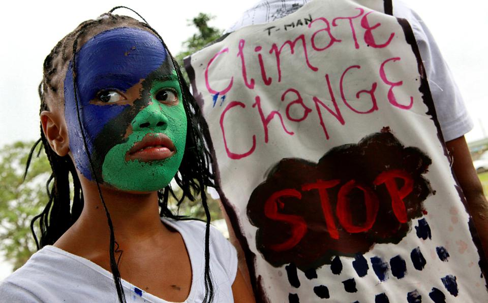 Schoolchildren with painted faces participate in a protest to support a global day of action on climate change, called "Climate Justice Now!", in Merebank, south of Durban, on December 12, 2009. The rally included performing skits, dance, drama and plays promoting the message of climate change as politicians from around the world gathered in Copennhagen, Denmark, to take part in the UN climate change conference. AFP PHOTO / RAJESH JANTILAL