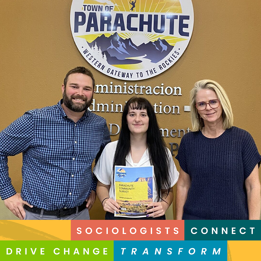 Madison Croissant and two people stand in front of a Town of Parachute sign. Madison holds a copy of the Parachute Community Survey report. CSU Sociology graphic reading “Sociologists Connect, Drive Change, Transform,” at the bottom.