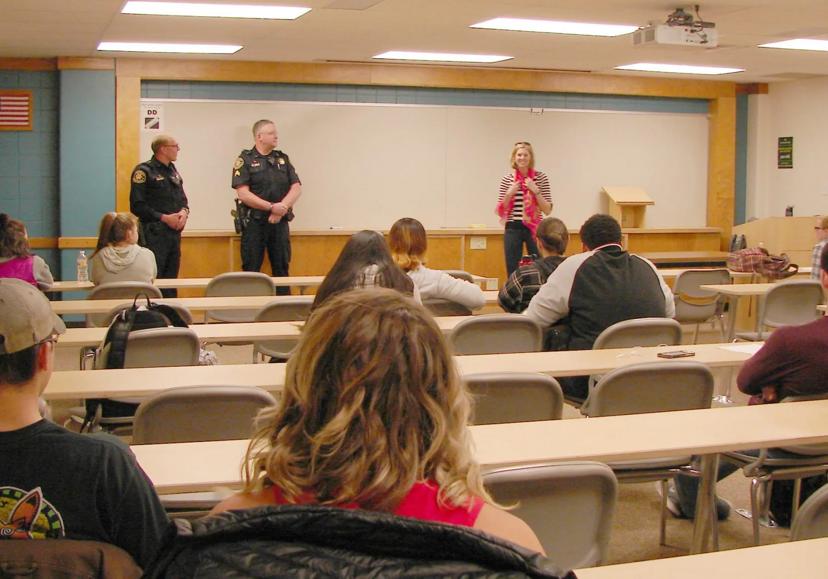 Two police officers present to a class about internship opportunities